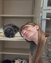 black cat lying next to new owner's head