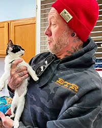 black and white kitten looking at her new owner